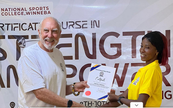 • Dr Kyle Pierce presenting a certificate to one of the graduating coaches