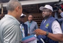 • Mr Annan interacting with a shop manager