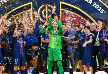 Goalkeeper Matvey Safonov celebrates with the trophy and his teammates