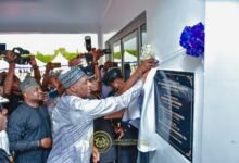 • Alhaji Muntaka unveiling a plaque at the commissioning of the Police Headquaters