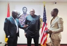 Kurt Okraku stressing a point to Ambassador Victor Smith (middle) and a staff of the embassy