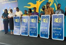 Winners of the promotion displaying their dummy cheques