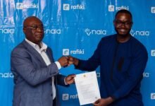 Mr Kisadha (right) displaying the approval letter by BoG