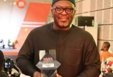 Mr Stanley Martey holding his plaque at the event