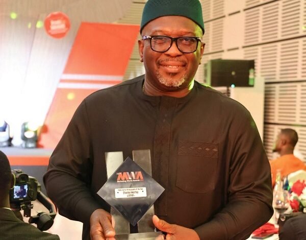 Mr Stanley Martey holding his plaque at the event