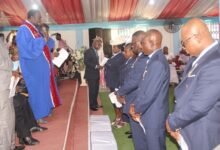 • Apostle Daniel Adu Asare (with mic) praying for the pastors at the ordination ceremony Photo: Ebo Gorman