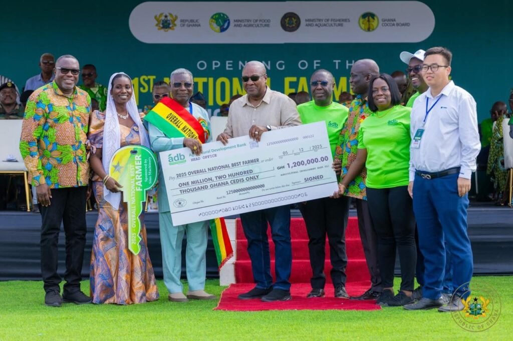 President Mahama (sixth from right) presenting the overall National Best Farmer dummy cheque to Mr Abraham Kwaku Adusei (third from left)
