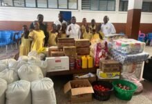 • Rev. Patrick Bawuah presenting the items to the school