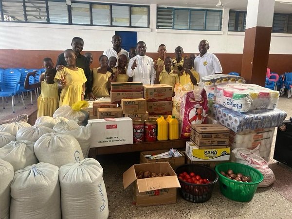 • Rev. Patrick Bawuah presenting the items to the school