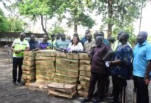 • Ms Linda Ocloo (middle) with the MMDAs before presenting the street lights Photo: Seth Osabukle