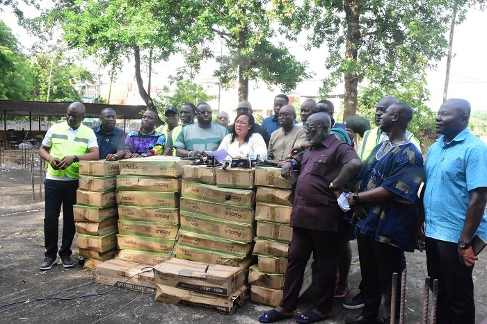 • Ms Linda Ocloo (middle) with the MMDAs before presenting the street lights Photo: Seth Osabukle