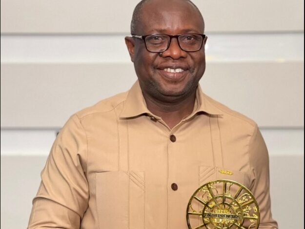 Mr Gyadu displaying the award