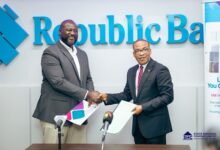 Mr Bawa (left) and Dr Dzoboku in a handshake after the signing ceremony