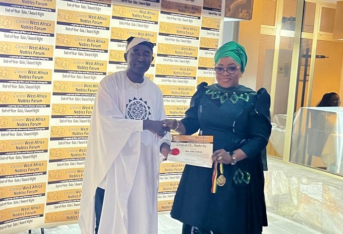 • Ms Shamima Muslim (right) receiving an award on behalf of the Chief of Staff, Mr Julius Debrah
