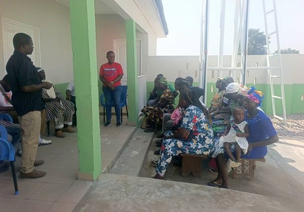 Staff of WaterAid Ghana emgaging communities members of Kodorogo, during the handover ceremony