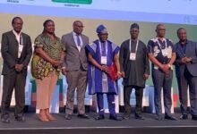 Mr Luc Bodea, Director of ICASA (middle) in a group photograph with other speakers at the event