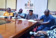 Dr Akanbong (right in mic) addressing journalists at the opening.