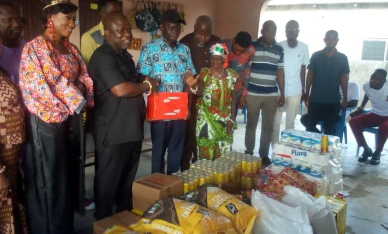 The Volta Regional Minister, Mr James Gunu (left) presenting the items to the Caretaker of the Cured lepers Village, Mr Gedion Atitso