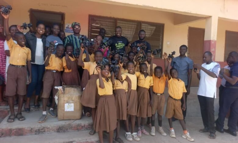 The MCE, Roland Atanga Ayoo, the Access Bank Bolgatanga Branch Manager, teachers, learners of the Yorogo-Akakiya KG/Primary School in a group picture after the donation