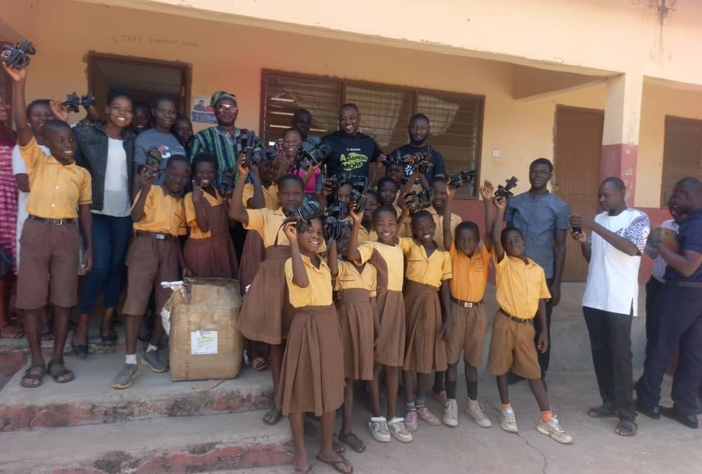 The MCE, Roland Atanga Ayoo, the Access Bank Bolgatanga Branch Manager, teachers, learners of the Yorogo-Akakiya KG/Primary School in a group picture after the donation