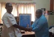 Mr CephasAveh (left) receiving a citation from Mr Koomson