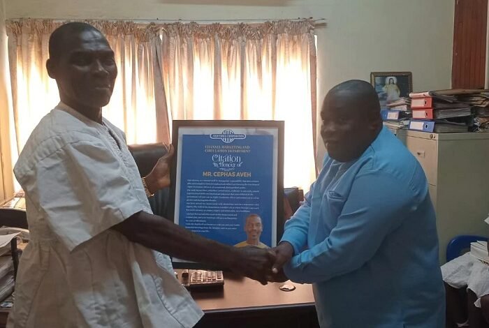 Mr CephasAveh (left) receiving a citation from Mr Koomson