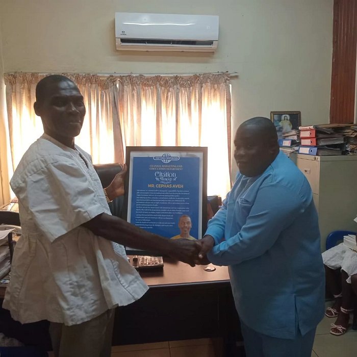 Mr CephasAveh (left) receiving a citation from Mr Koomson