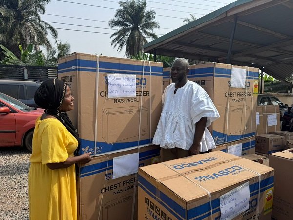 • Mr Ibrahim presenting a deep freezer to a beneficiary
