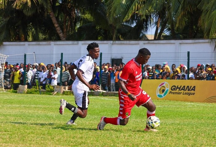 • A Kotoko player (in red) marked closely by a Swedru All Blacks player
