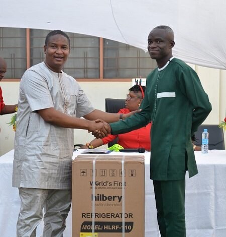 Mr Ramadan(left)presenting the overall best worker award to Mr Abdul Fatawa Rahman.