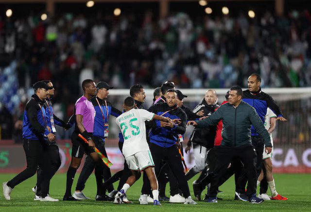 Algeria's Rafik Belghali clashes with match officials after the match