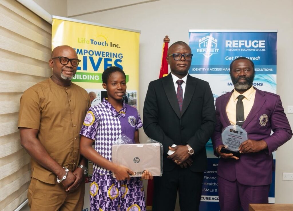 • Ama Korama Adu with the Minister of Sports and Recreation, Mr Kofi Adams, after the presentation. With them are Mr Moses Adu (right), father and coach of the player and Mr Samuel Anim Addo (left)