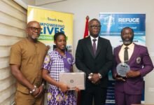 • Ama Korama Adu with the Minister of Sports and Recreation, Mr Kofi Adams, after the presentation. With them are Mr Moses Adu (right), father and coach of the player and Mr Samuel Anim Addo (left)
