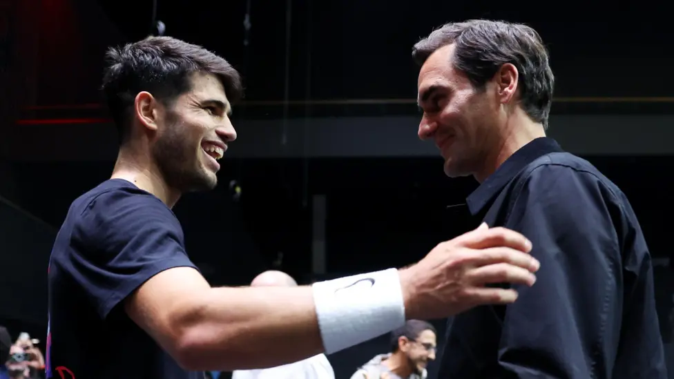 Carlos Alcaraz (left) with Roger Federer