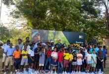 • Danny List (arrowed) with officials and some of the junior golfers