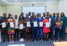 • Dr Agyepong with President and members of the GSD displaying copies of the MoU