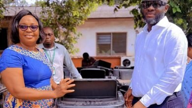 Mr Ibrahim (right) presenting dustbins to representatives schools