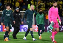 Erling Haaland and teammates walk off the field after the game