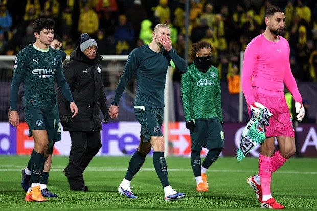 Erling Haaland and teammates walk off the field after the game
