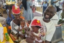 Mr Anderson carrying one of the children at the party