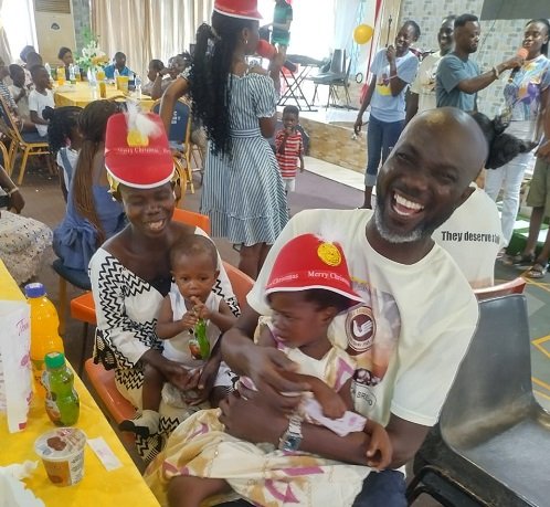 Mr Anderson carrying one of the children at the party