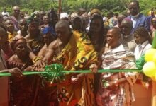 Nana Nketsia V supported by DrAmoh (left) to cut tape to inaugurate the Justmoh Block ‘A’