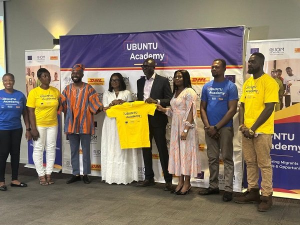 Mr Mbay (in suit) with Ms Ndiaye display Ubuntu Academy souvenir