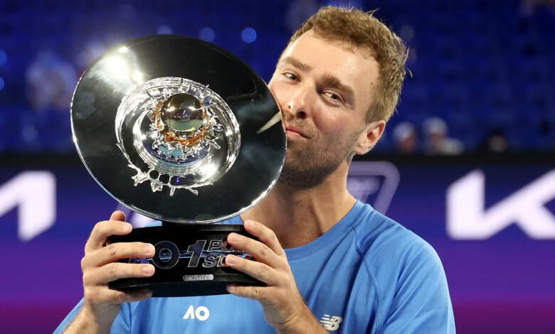 Jordan Smith celebrates with the trophy after defeating Taiwan's Joanna Garland