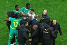 Morocco's Achraf Hakimi, center, clashes with Senegal players during the final