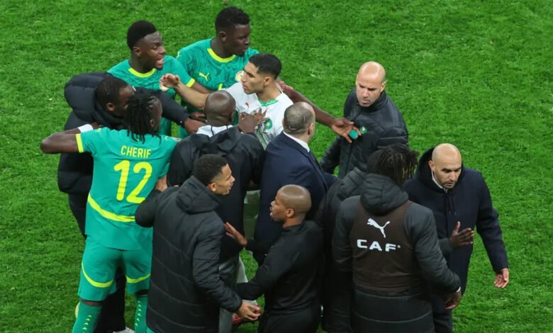 Morocco's Achraf Hakimi, center, clashes with Senegal players during the final