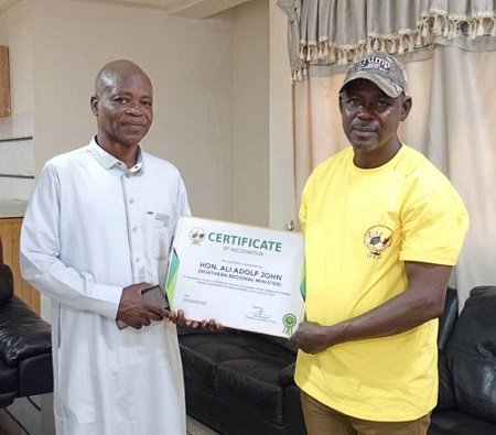 • Mr Issifu Basideen (right) presenting the certificate to Northern Regional Minister, Mr Ali Adolf John Mburidiba