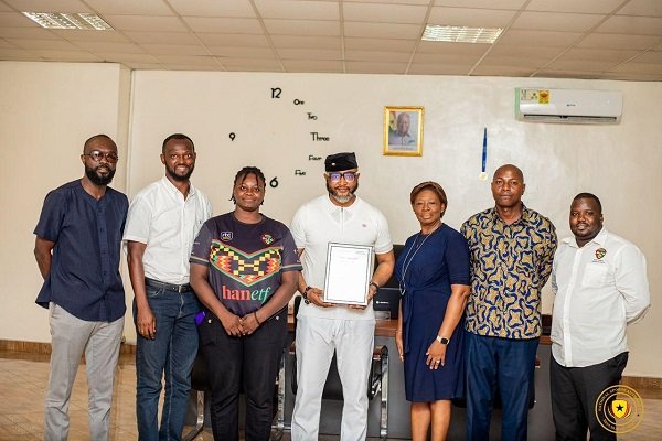 NSA boss Mr Ampofo Ankrah (middle) displaying the certificate. With him are Madam Storey (right) and staff of the RLFG and NSA
