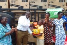 • Alhaji Fuseini (second left) presenting some items to a beneficiary.