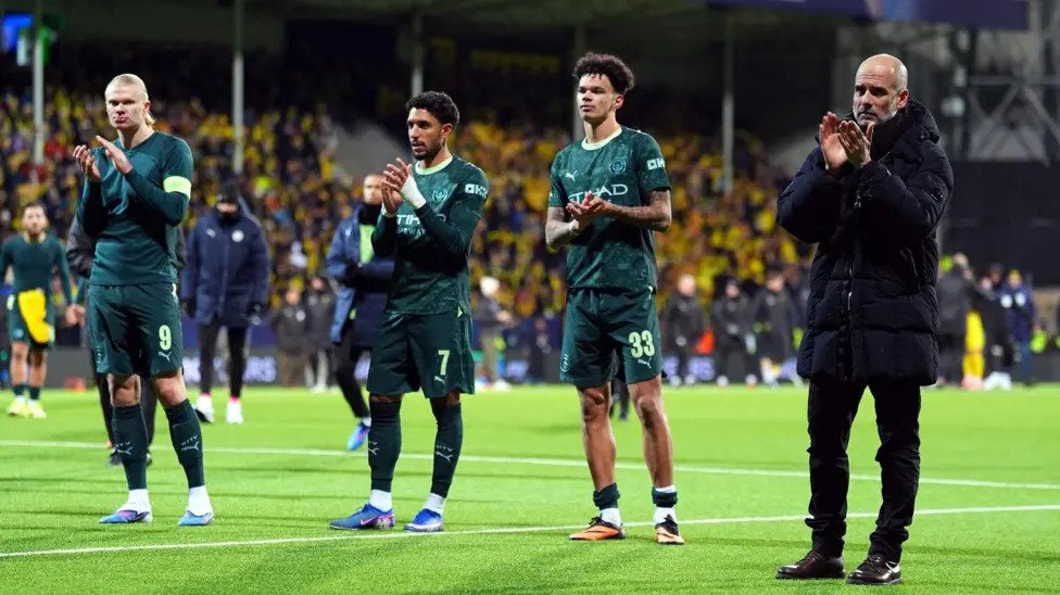 Pep Guardiola leads his players to acknowledge cheers from the City fans after the game